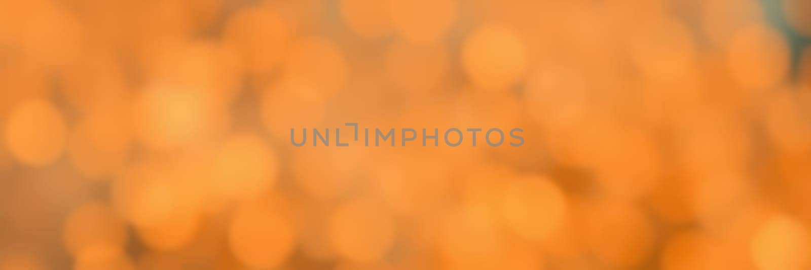 Soft, warm orange lights create a cozy ambiance, enhancing the inviting atmosphere of a gathering during the evening. A focal point for social interaction is evident.