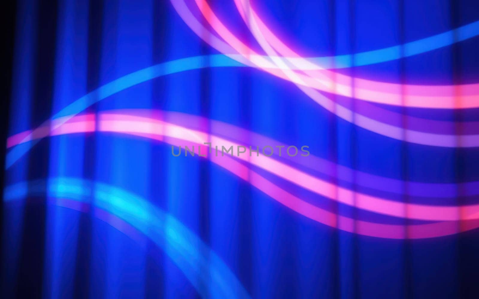 Vibrant streams of blue and pink light flow gracefully across a dark surface, creating an energetic atmosphere during a lively evening gathering.
