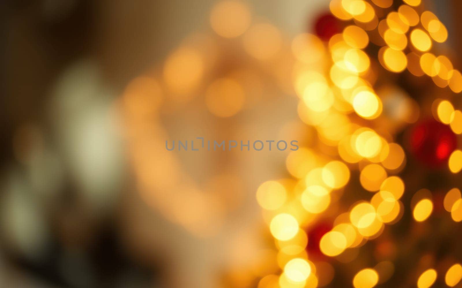 Warm golden lights twinkle on a beautifully decorated Christmas tree, creating a festive atmosphere in an inviting indoor space. The soft glow enhances holiday cheer.