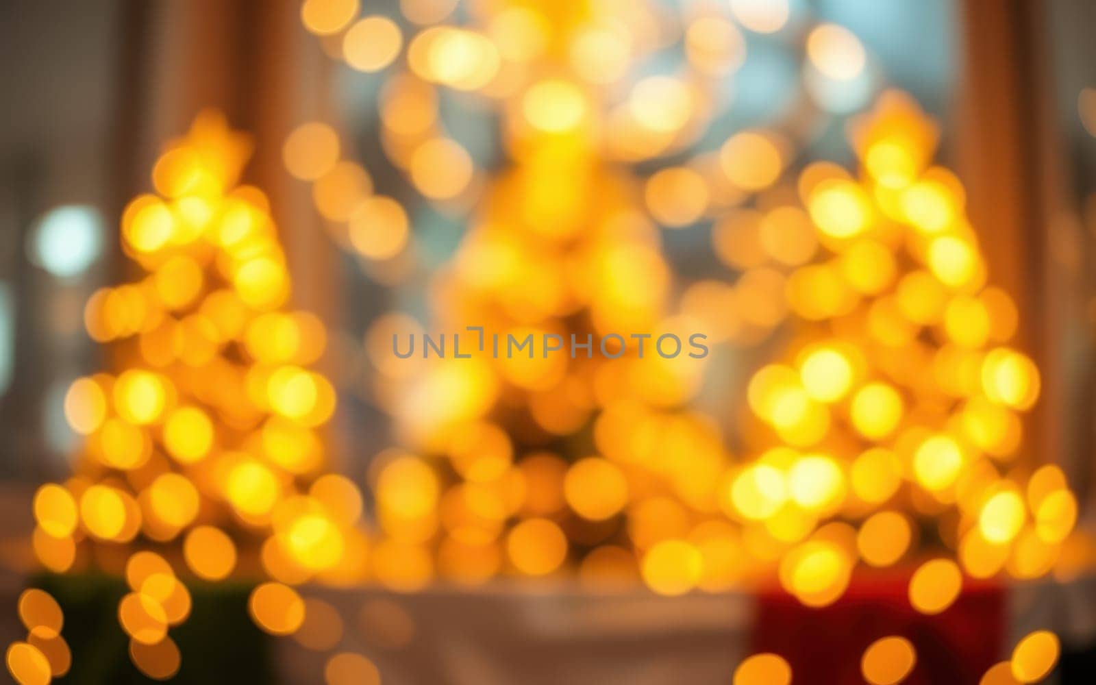 Soft, blurred lights illuminate several Christmas trees, creating a magical atmosphere in a warm indoor space decorated for the holidays. The golden glow enhances the festive spirit.