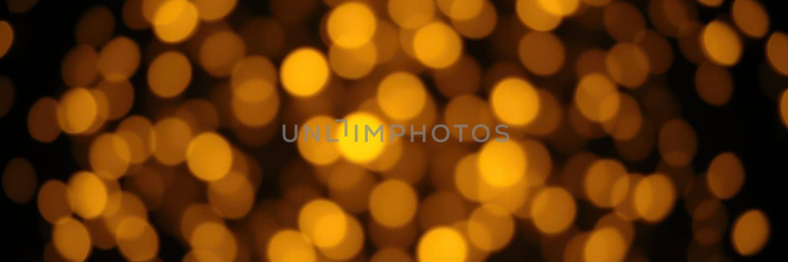 Soft golden bokeh lights illuminate the surroundings, creating a cozy atmosphere perfect for a festive gathering or celebration at night.