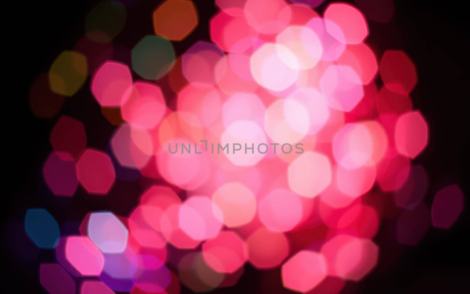 A stunning array of colorful bokeh lights fills the background during a night festival, illuminating the city square with a joyful ambiance for attendees to enjoy.