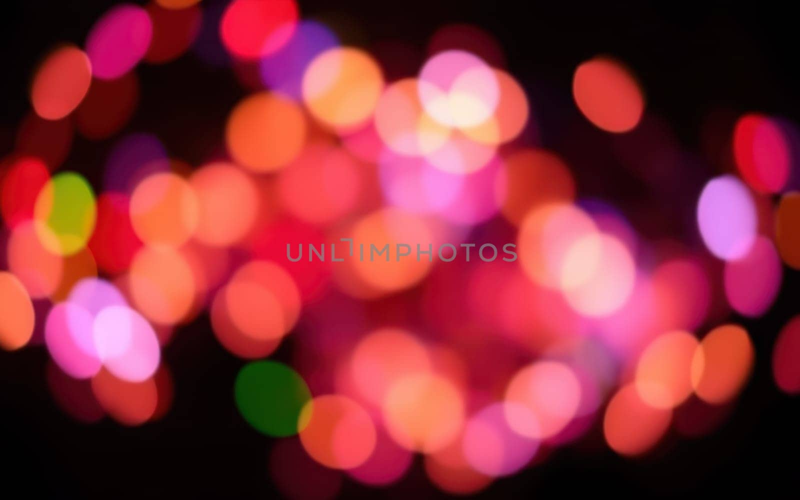 Soft, blurred lights in various colors illuminate the surroundings, creating a joyful ambiance typical of nighttime festivities in an urban area.