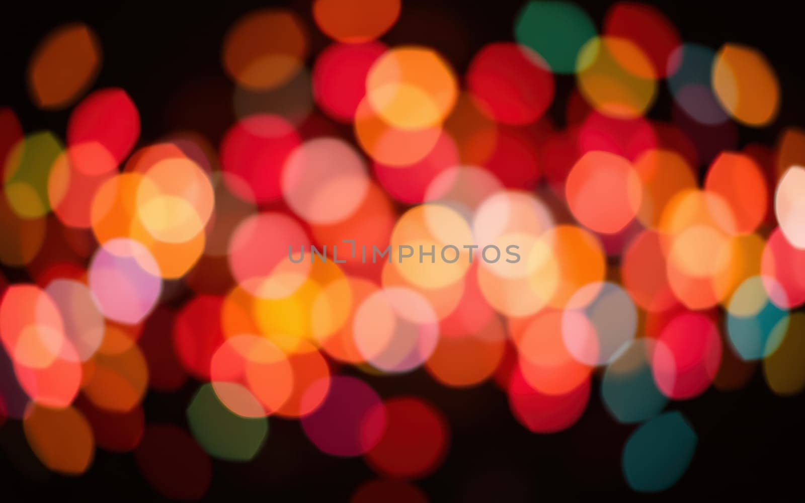 Bright and colorful lights in shades of red, orange, green, and yellow create a lively and warm atmosphere, perfect for celebrations or gatherings during the evening hours.