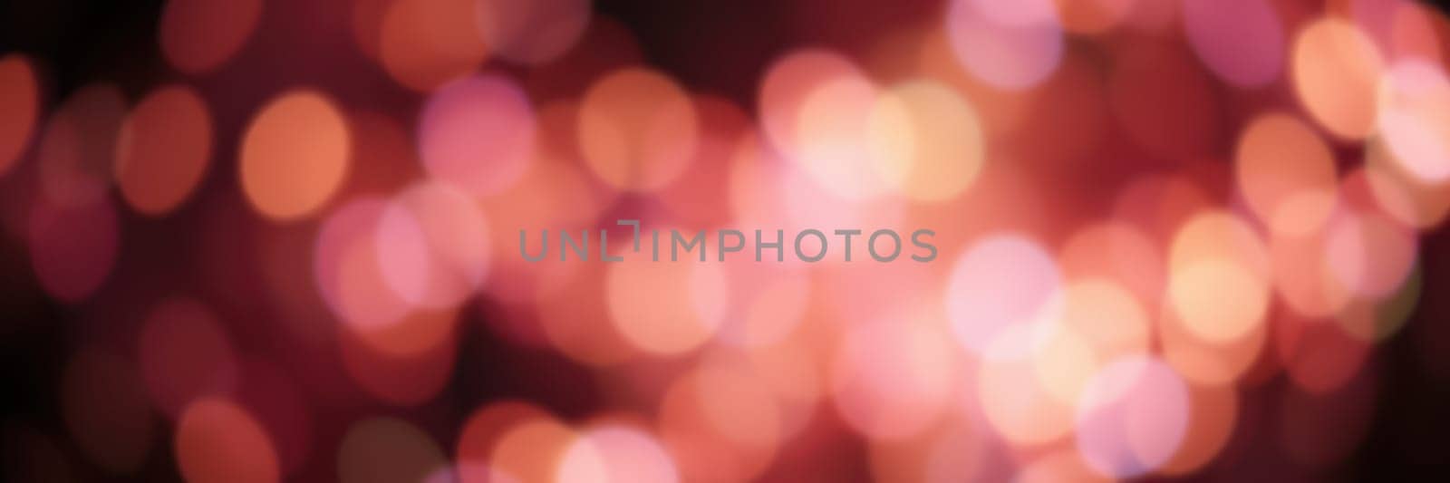 Bright, colorful lights blur together, creating a warm and vibrant atmosphere during a nighttime celebration. The soft glow adds a magical touch to the event.