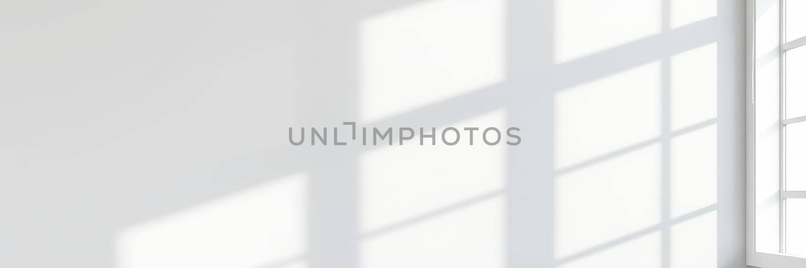 Bright daylight enters through large windows, creating soft, patterned shadows on a crisp white wall. The serene atmosphere evokes a peaceful and inviting ambiance.