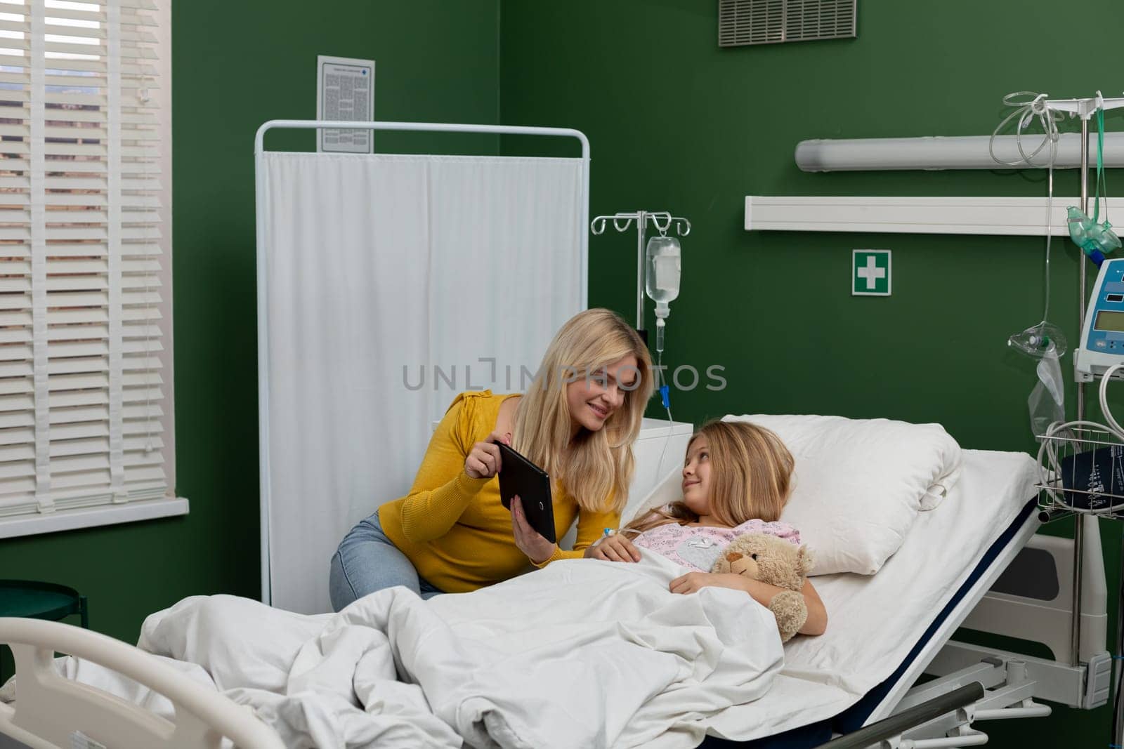 A touching and caring moment shared between a devoted mother and her beloved child within a hospital setting