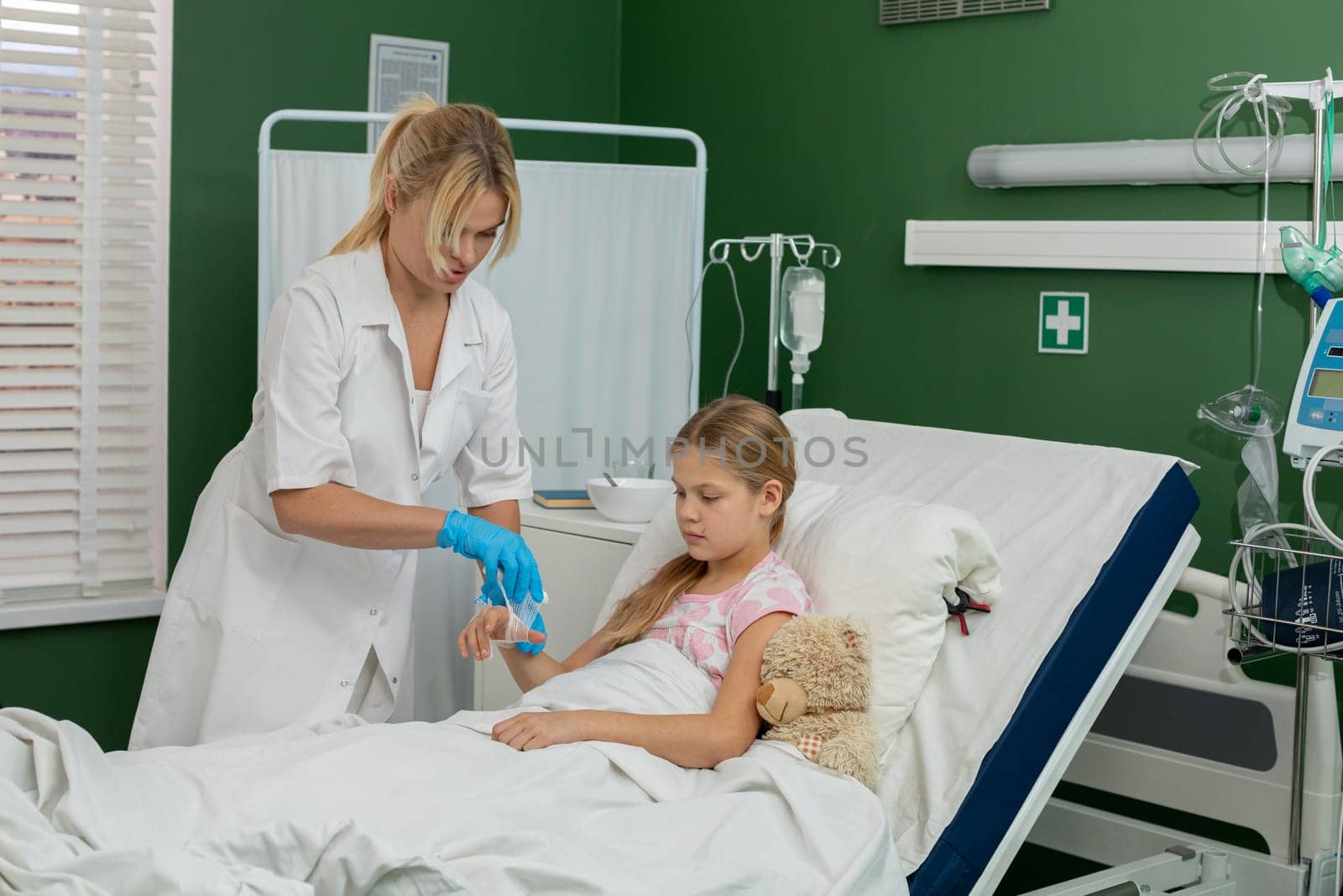 In a hospital environment, a caring nurse diligently administers medical care to a young patient in need