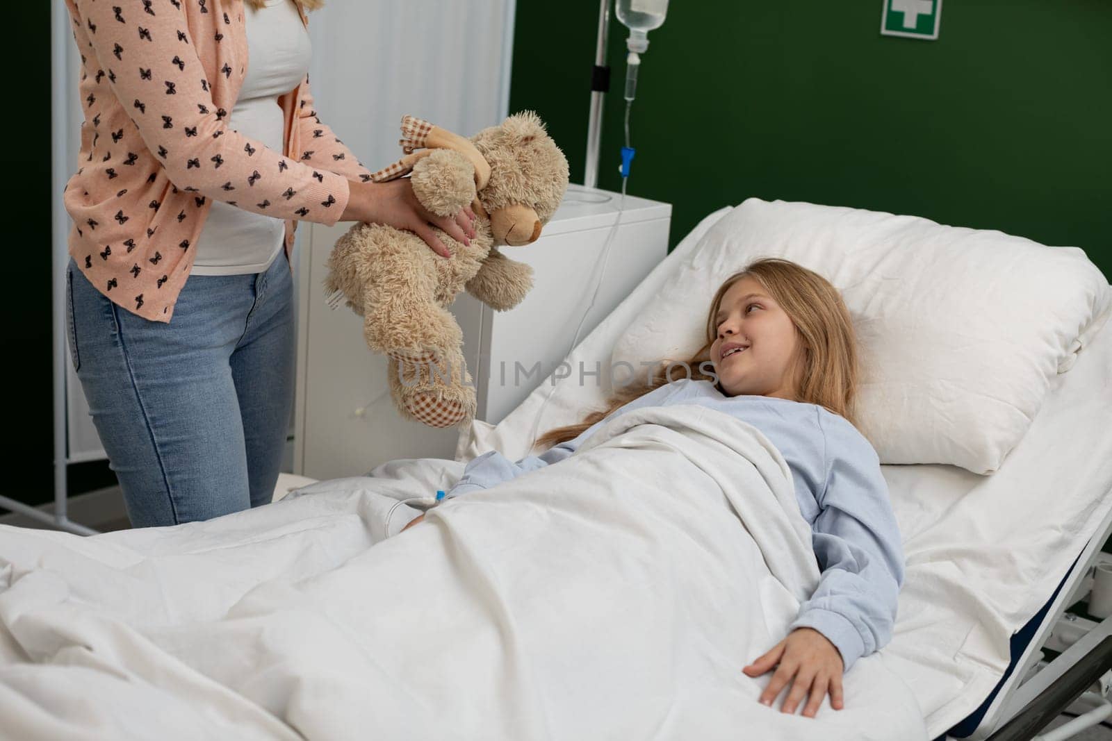 A warm and nurturing scene of a child in a hospital bed receiving comforting companionship from a teddy bear