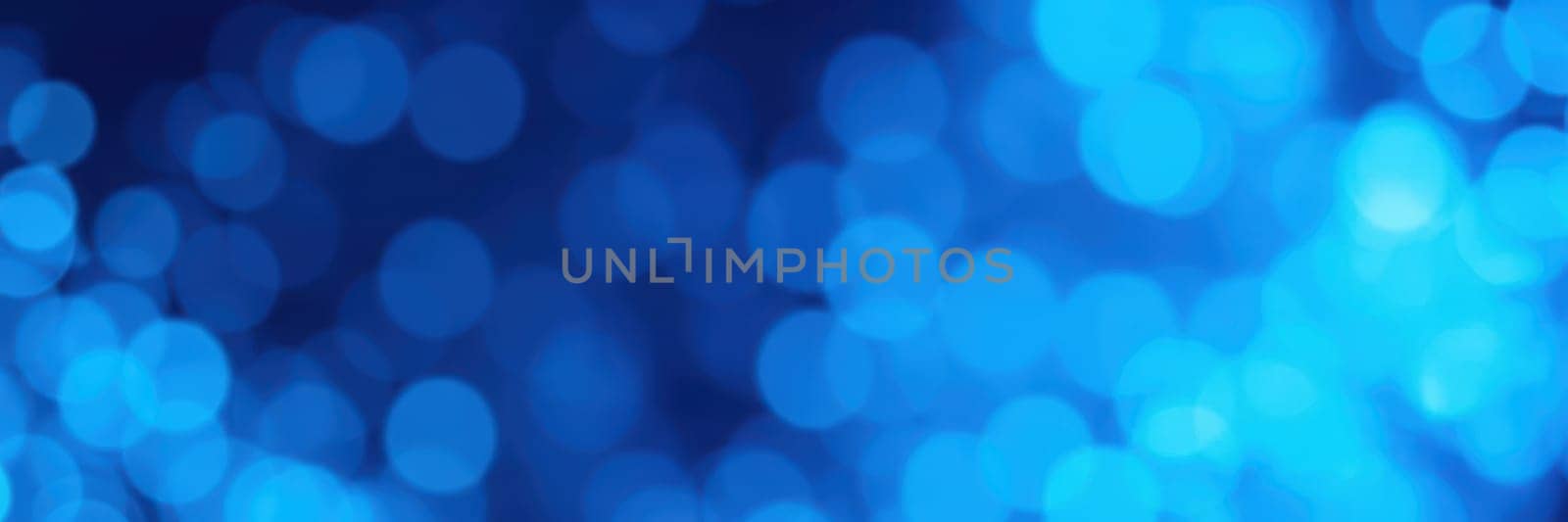 A colorful display of blue bokeh lights fills the background, creating a dreamy atmosphere. This enchanting scene captures the essence of a lively evening event, perfect for celebrations.