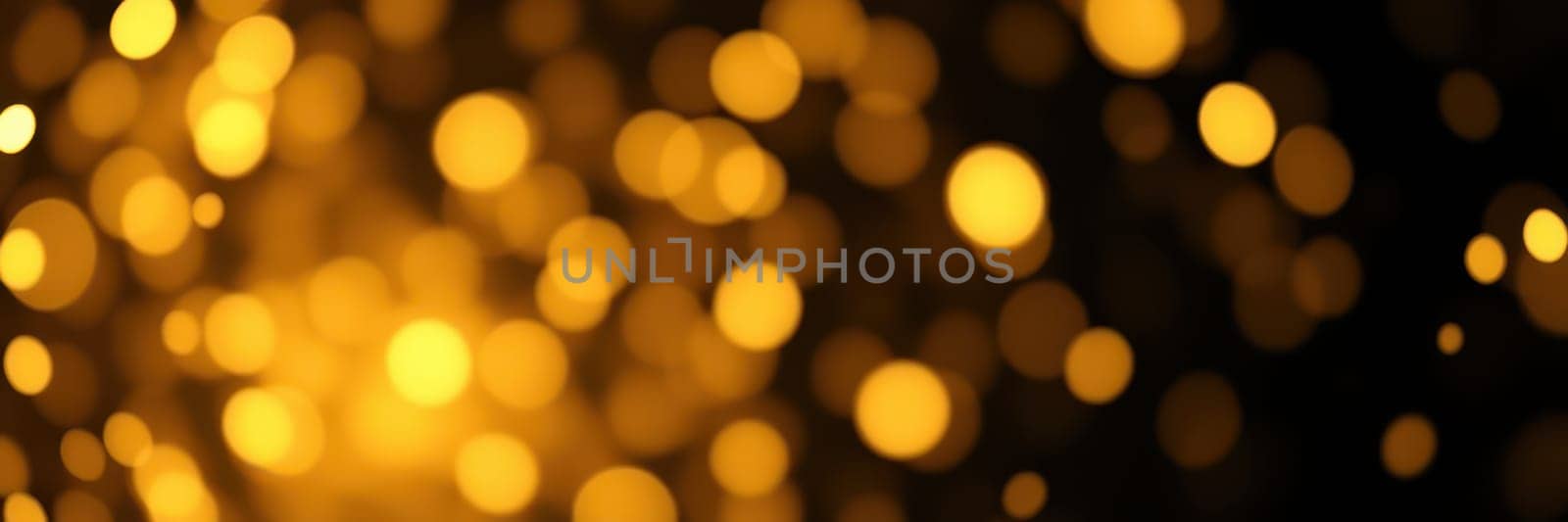 Soft, glowing golden lights create a magical ambiance in a celebration. The vibrant bokeh effect enhances the joyful atmosphere of the evening event.