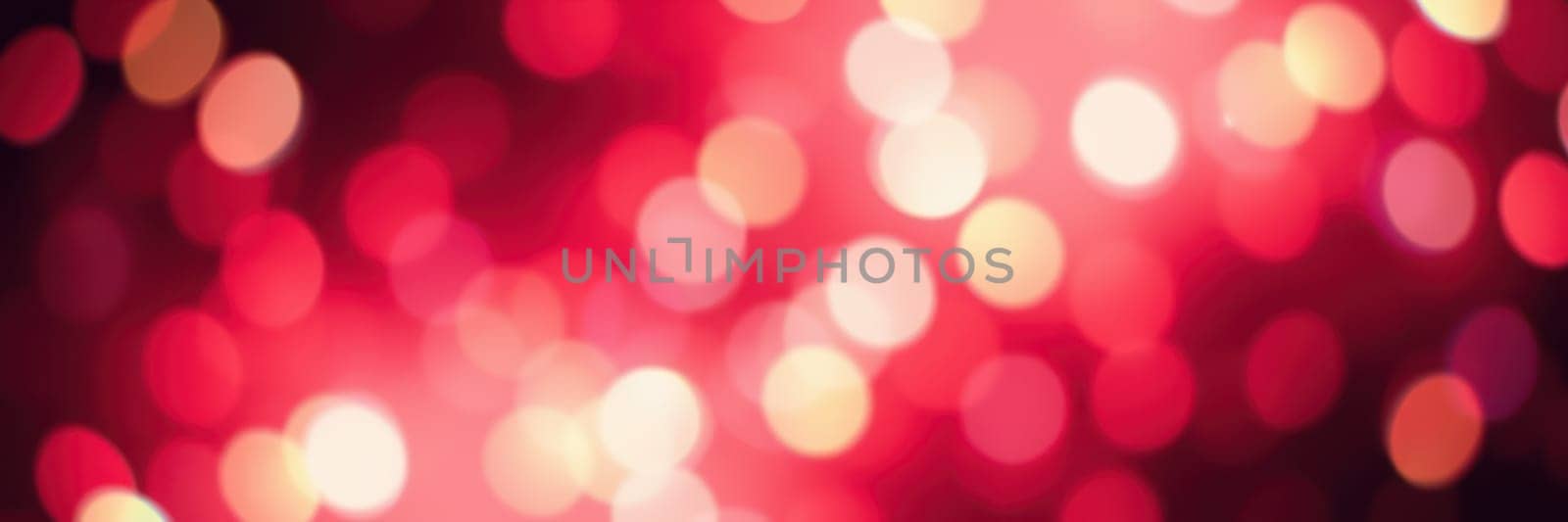 Colorful bokeh effects of red and white lights illuminate the background, suggesting a lively celebration in an urban area during the night.