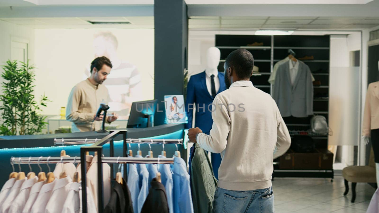 Male shopper buying formal or casual wear in boutique by DCStudio