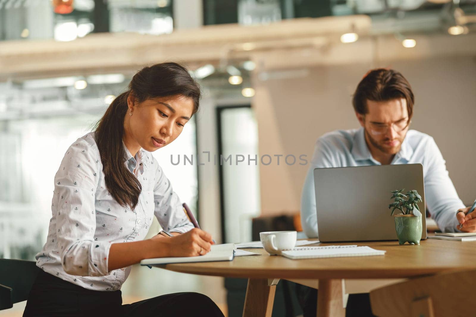 Two diverse business people working in modern coworking space. High quality photo