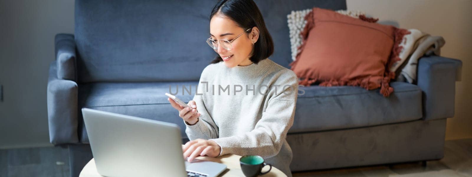 Portrait of working businesswoman using laptop, work on remote. Korean girl with computer, shops online.