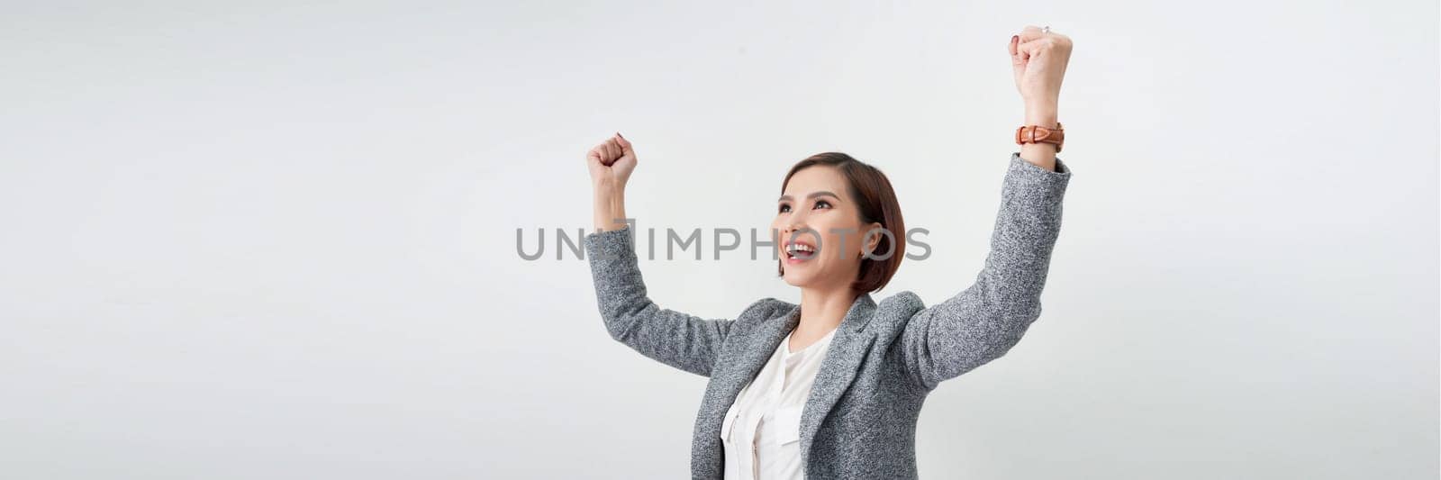 Successful business woman with arms up - isolated over a white background. banner by makidotvn
