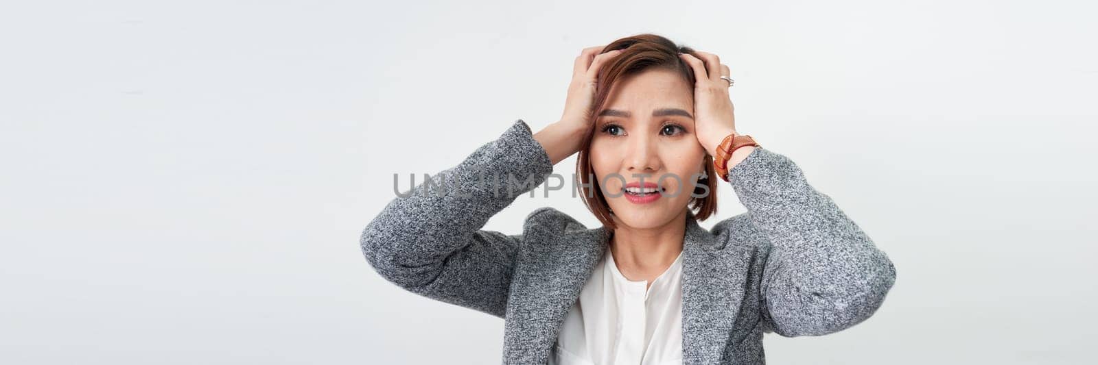 Emotional lady shouting in anger, being aggressive or mad, suffering from stress. headache