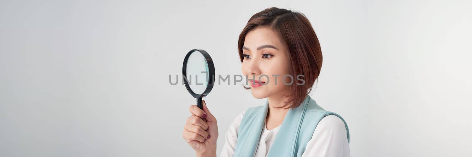 Banner of business woman with magnifying glass isolated on grey background.