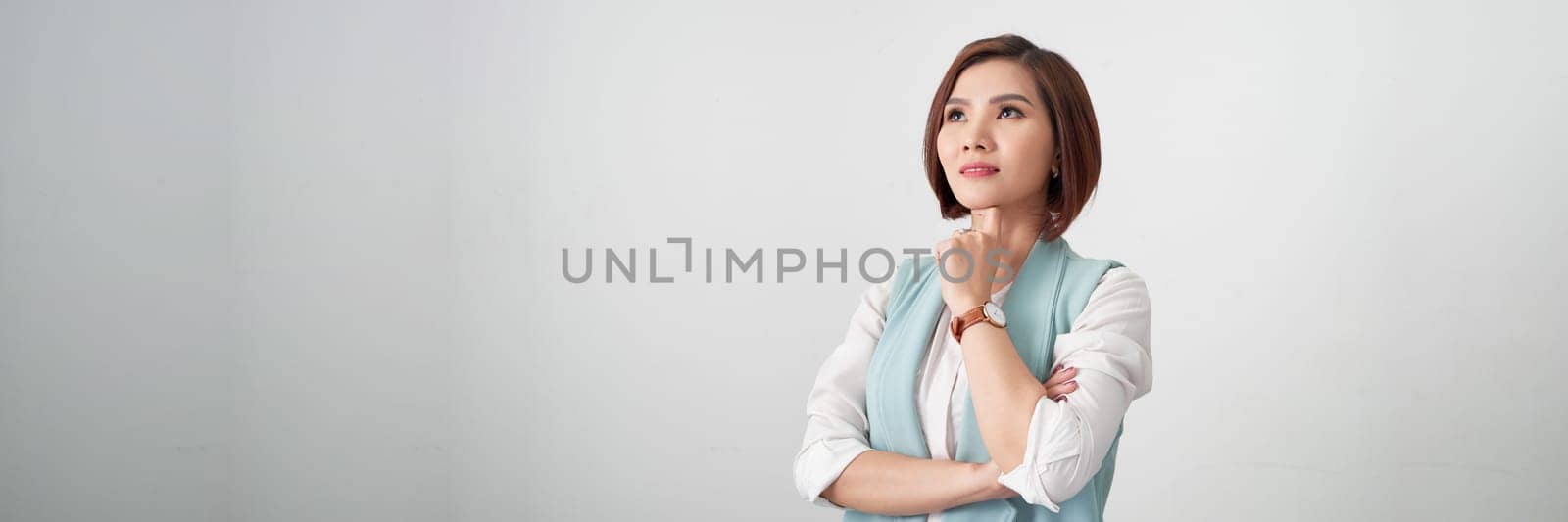 Beautiful young asian woman on a gray background in a white blouse. Panorama by makidotvn