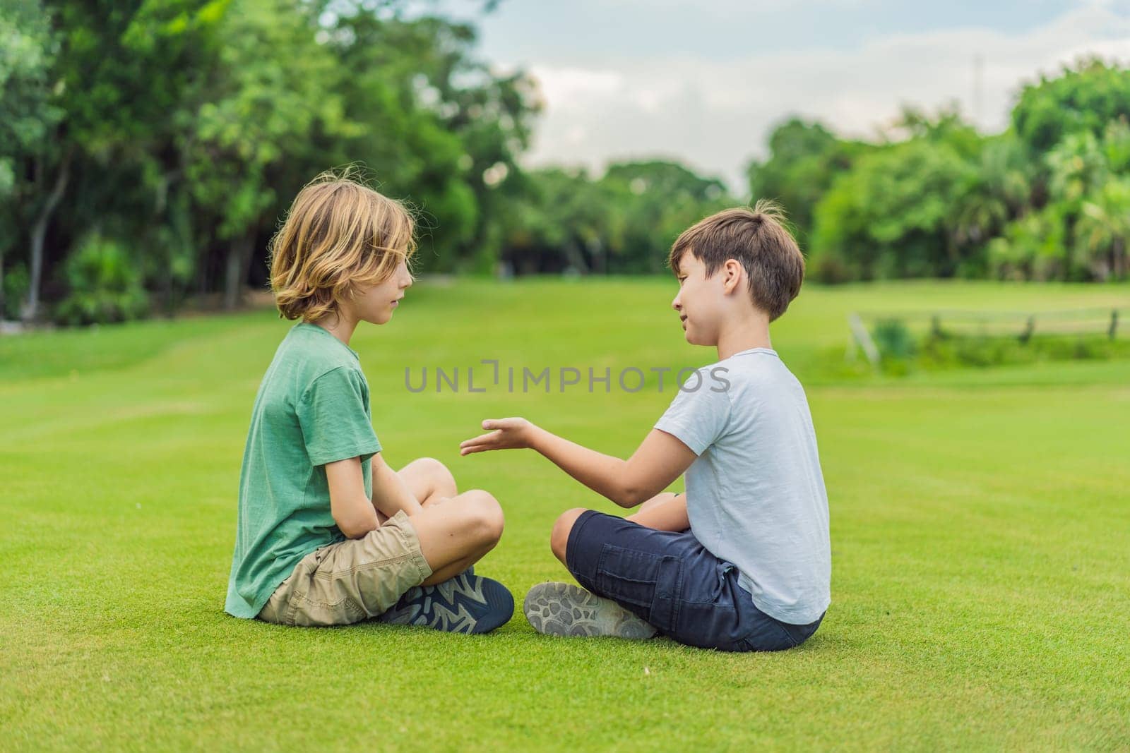 Two young boys share laughter and adventures in the sunlit park, cherishing the bonds of friendship and carefree moments.