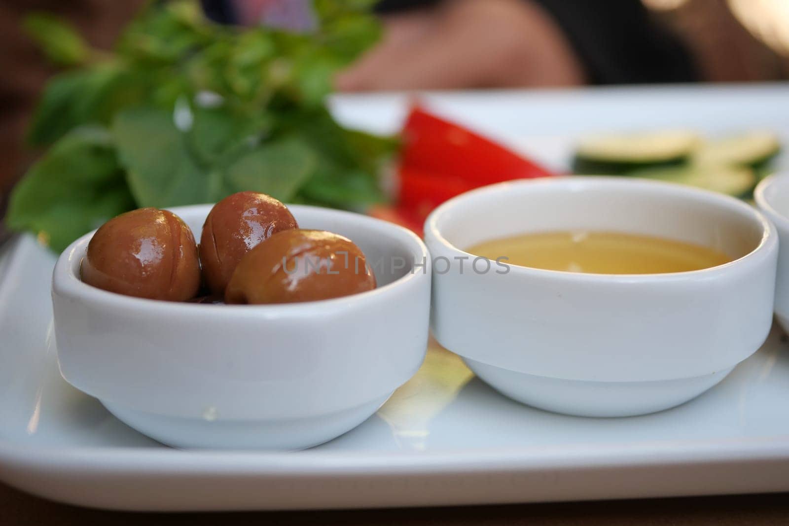A vibrant array of colorful appetizers with delectable dips and fresh, aromatic herbs