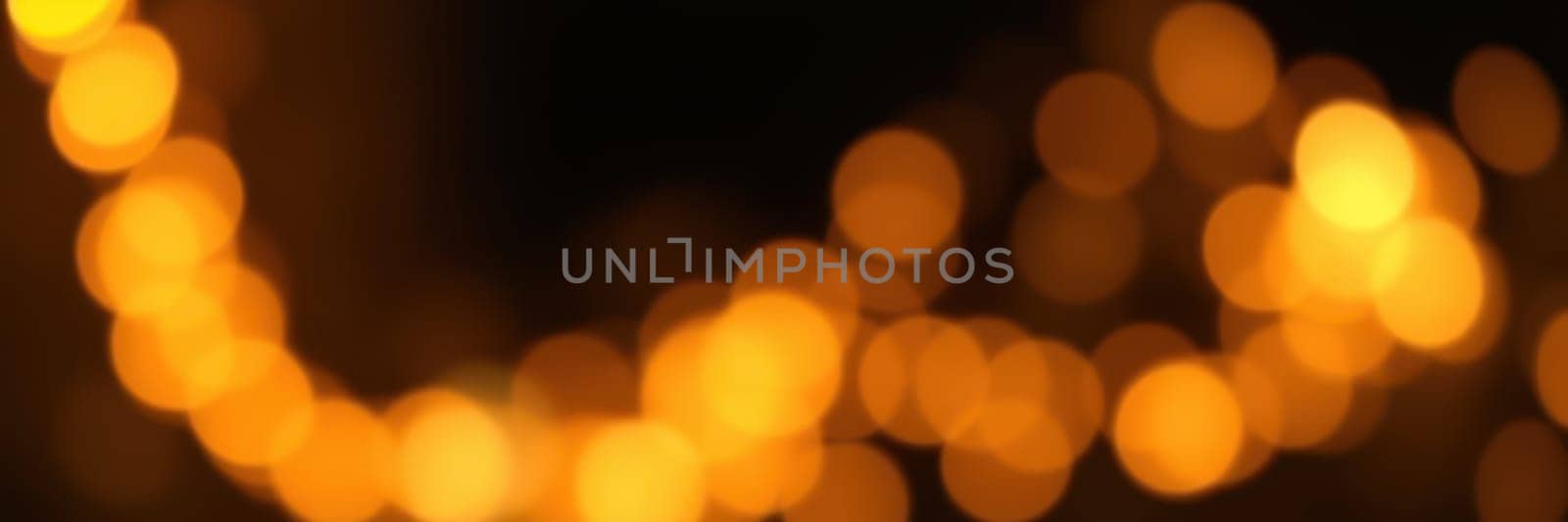 Soft, glowing lights illuminate a warm atmosphere, perfect for evening gatherings. The golden hues enhance the festive mood, inviting joy and relaxation among guests.