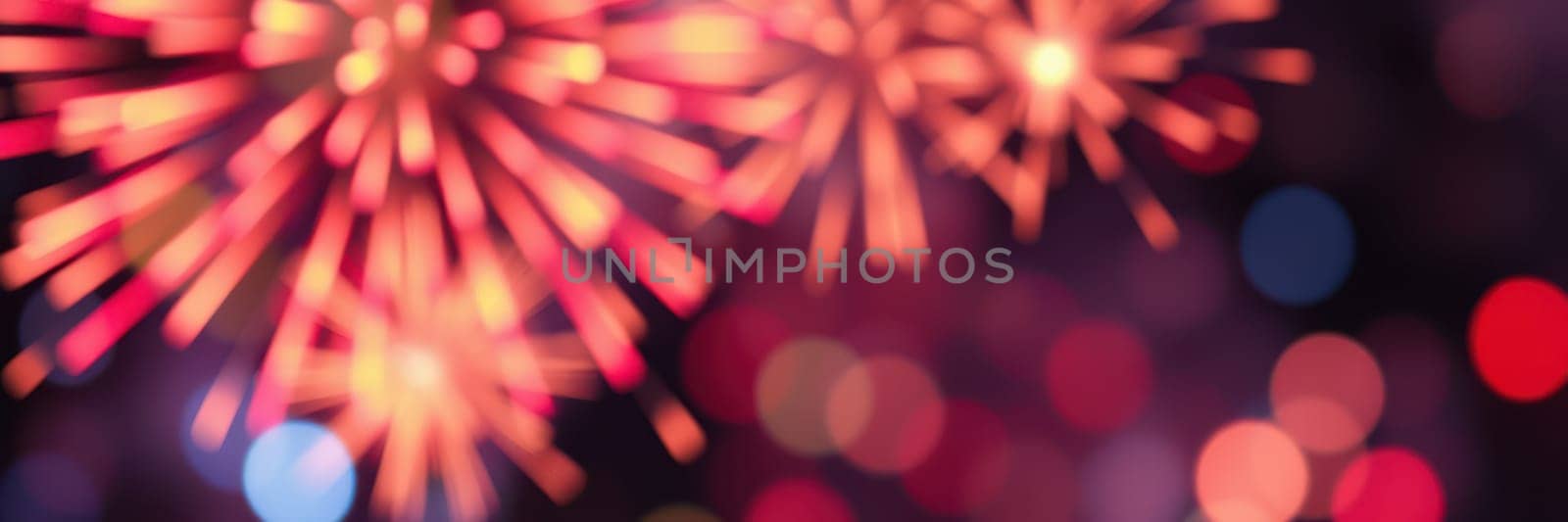 Bright fireworks burst in various colors over a bustling city, creating a festive atmosphere. The night sky sparkles with light as people enjoy the celebration.