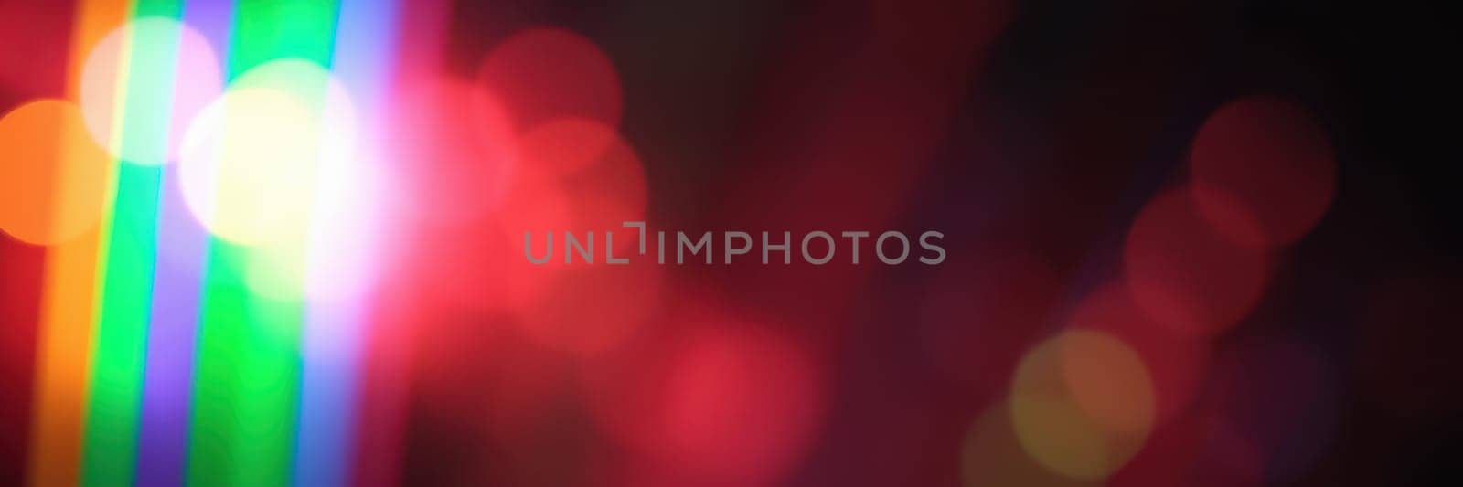 Bright lights create stunning patterns in various colors, showcasing an artistic arrangement at a lively nighttime event in the city, enhancing the festive atmosphere.