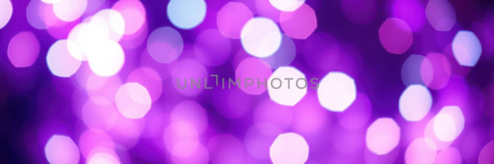 A multitude of purple and white bokeh lights create a magical ambiance during an evening event in an urban setting. People enjoy the festive atmosphere together.