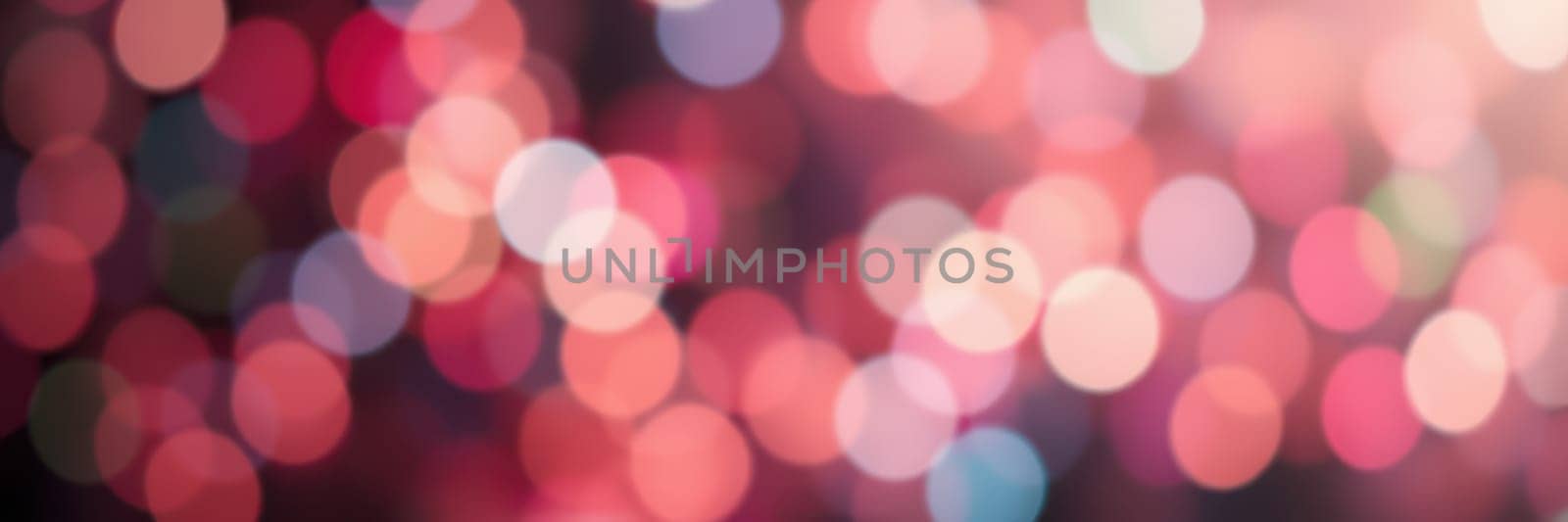 Vibrant and softly blurred bokeh lights in warm hues create an enchanting ambiance ideal for festive occasions and joyful gatherings, evoking a sense of celebration.