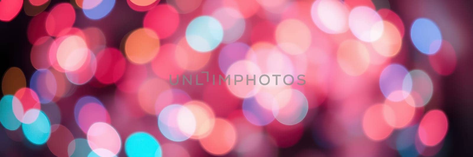 A captivating display of out-of-focus colorful lights fills the background, adding a joyful and vibrant ambiance to a festive occasion during the evening.
