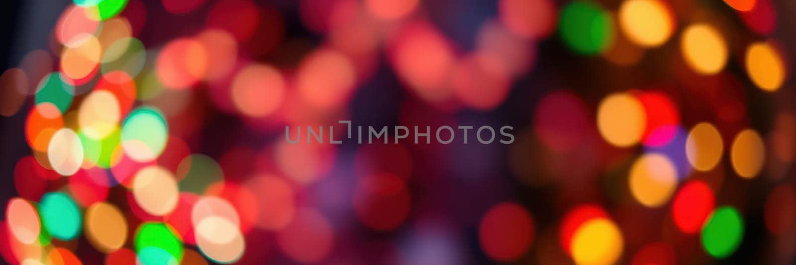 Bright, colorful lights illuminate a lively urban area, casting a cheerful glow as people gather for a festive celebration. The atmosphere is filled with joy and excitement.