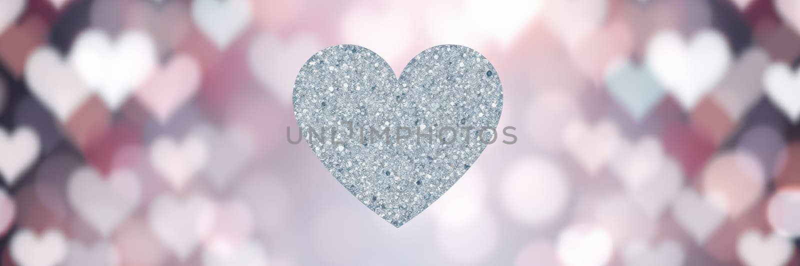A shimmering silver heart glitters prominently against a soft bokeh background filled with pastel colors. This festive setting radiates warmth and joy, perfect for expressing love.