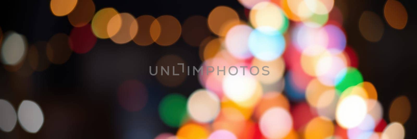 Vibrant lights create a lively atmosphere during a celebration at night, enhancing the festive spirit with colorful hues and cheerful energy throughout the scene.
