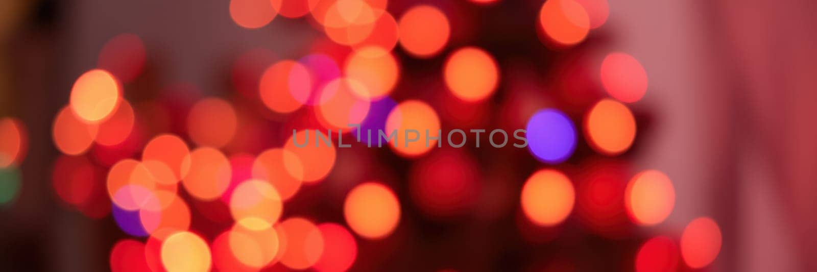 Bright and colorful lights create a warm atmosphere in an indoor setting, enhancing the festive spirit during winter celebrations and family gatherings this holiday season.