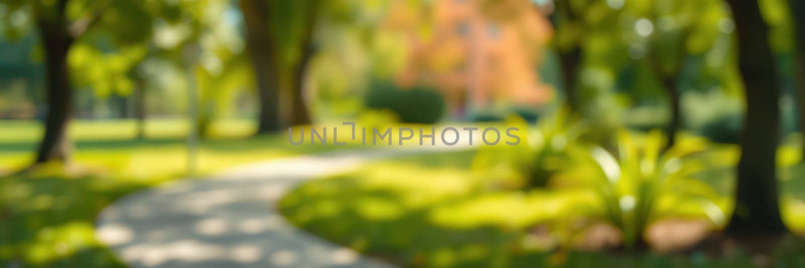 A winding pathway leads through a vibrant park filled with lush greenery and colorful autumn foliage under a bright blue sky. People enjoy leisure time in the peaceful setting.