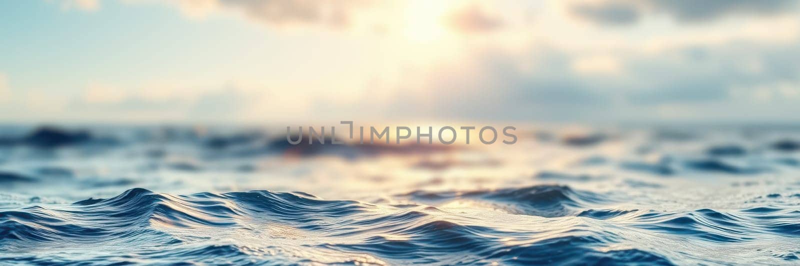 The vast ocean stretches under a golden sky, showcasing gentle waves reflecting the warm hues of sunset. The scene evokes a sense of calm and serenity along the shoreline.
