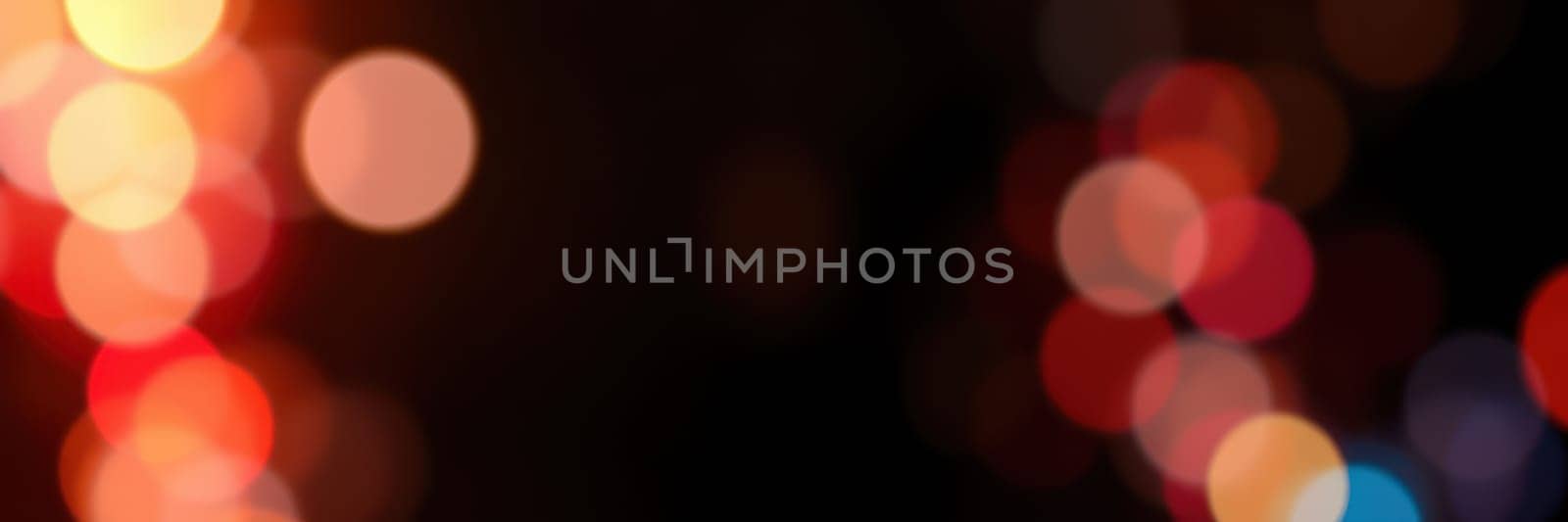 Vibrant bokeh lights in red, orange, and yellow fill the background, enhancing the warm, festive atmosphere ideal for gatherings during celebrations.