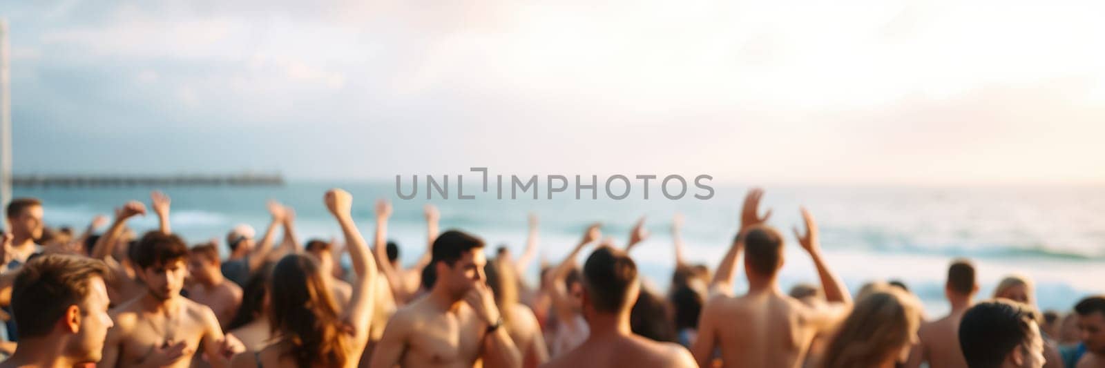 A lively gathering takes place at the beach with people celebrating and dancing. The sun sets over the ocean, creating a festive atmosphere filled with joy and excitement.