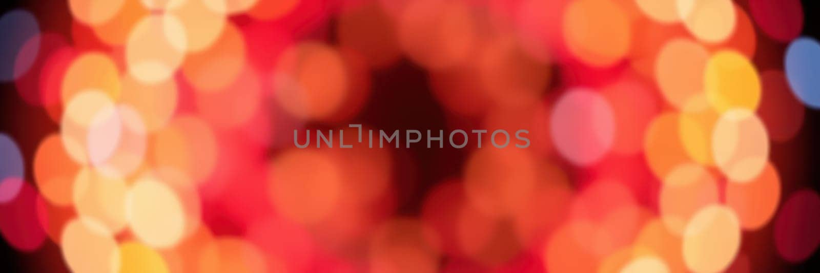 Colorful bokeh lights illuminate the atmosphere during a vibrant evening celebration, creating a warm and inviting mood for attendees to enjoy.