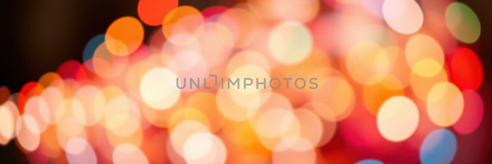Brightly colored bokeh lights fill the background, creating a vibrant and cheerful ambiance for the evening gathering in a city setting. The atmosphere is lively and inviting.