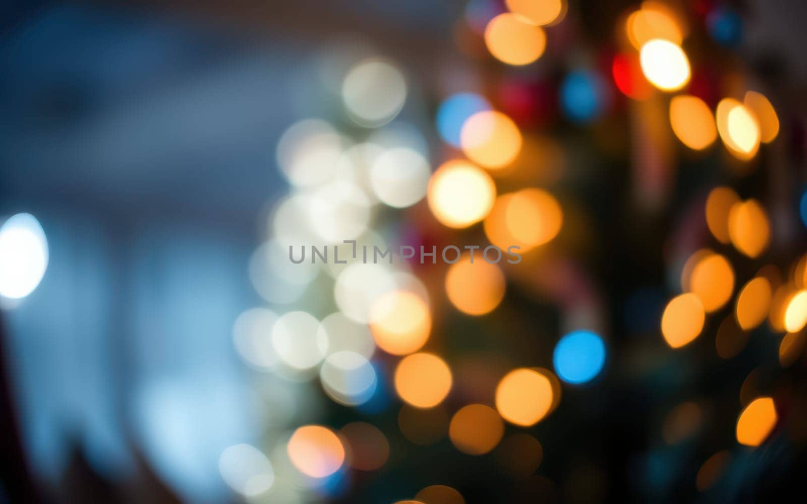 Softly blurred lights in various colors adorn a Christmas tree in a cozy indoor space, illuminating the room with a warm and festive glow, perfect for celebrating the holiday season.
