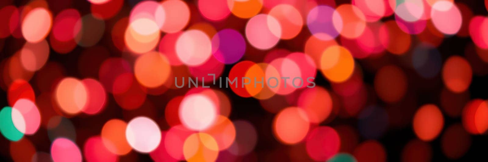 Bright and vibrant bokeh lights blur beautifully, filling the cozy atmosphere with warmth and excitement during a festive evening gathering with loved ones.