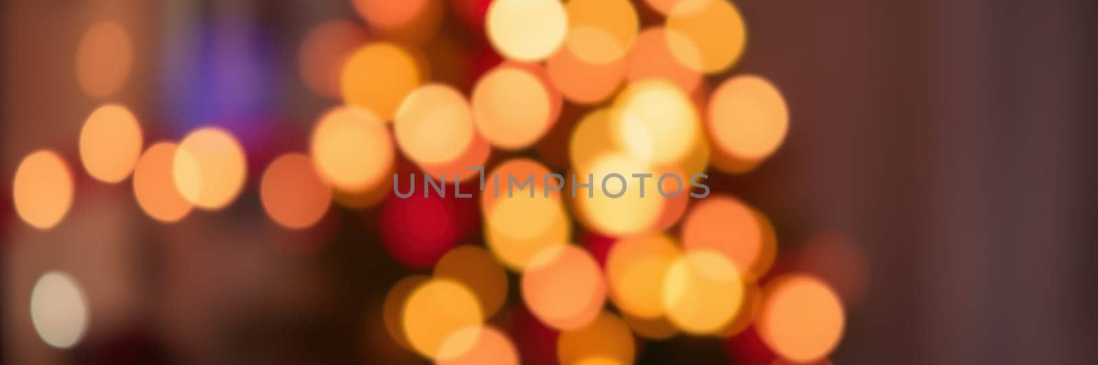 Colorful lights twinkle on a decorated tree, creating a warm and inviting ambiance in a home during a winter evening celebration filled with laughter and joy.