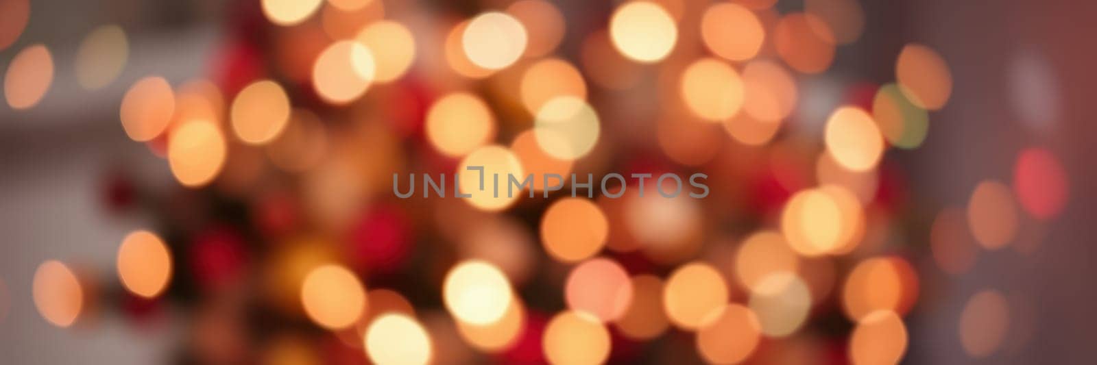 Softly glowing holiday lights illuminate a room, creating a warm and inviting ambiance. The colorful bokeh effect adds a magical touch to the winter celebration.