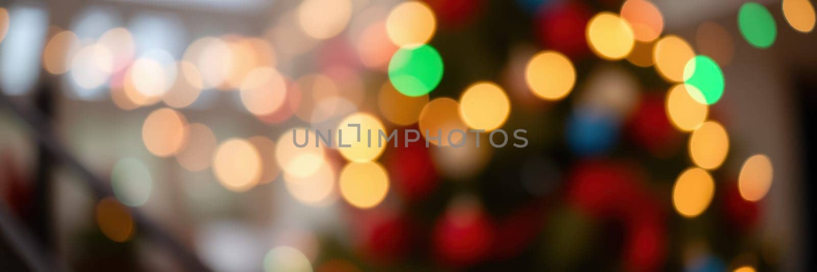Twinkling lights in various colors illuminate a warm indoor setting, creating a joyful holiday atmosphere. This cozy environment evokes feelings of celebration and togetherness.