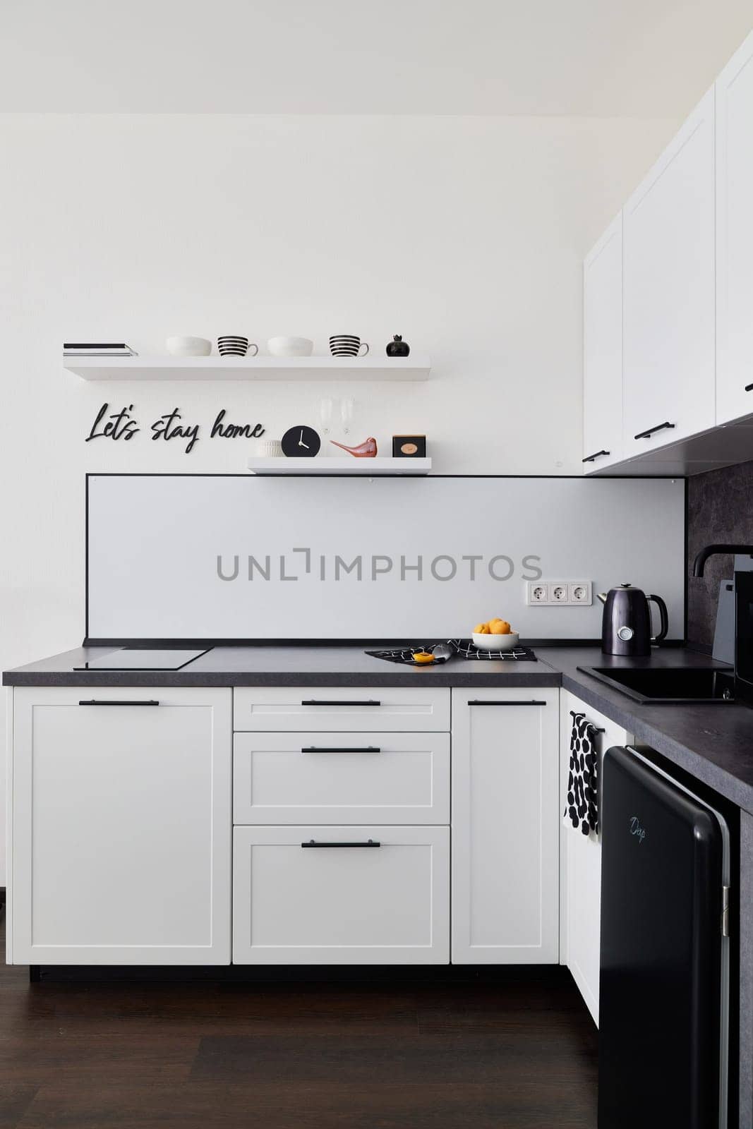 This stylish minimalist kitchen boasts sleek cabinetry complemented by contemporary modern appliances