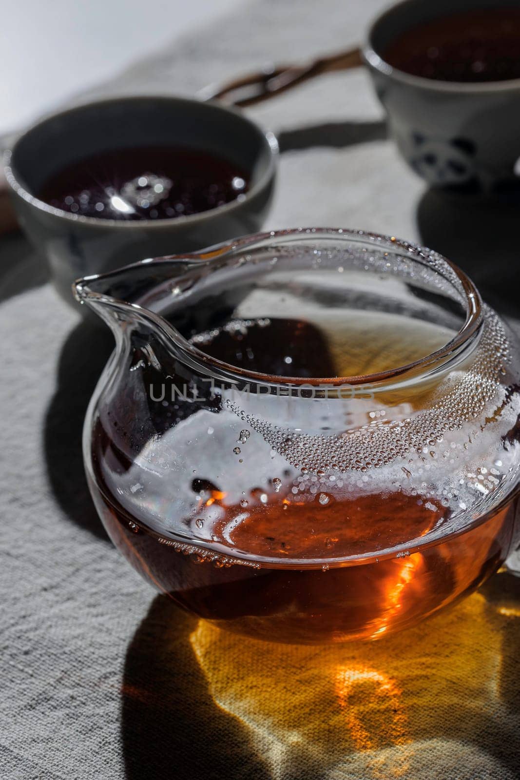 A beautifully serene display of tea artfully arranged in a glass pot, capturing warmth and tranquility perfectly