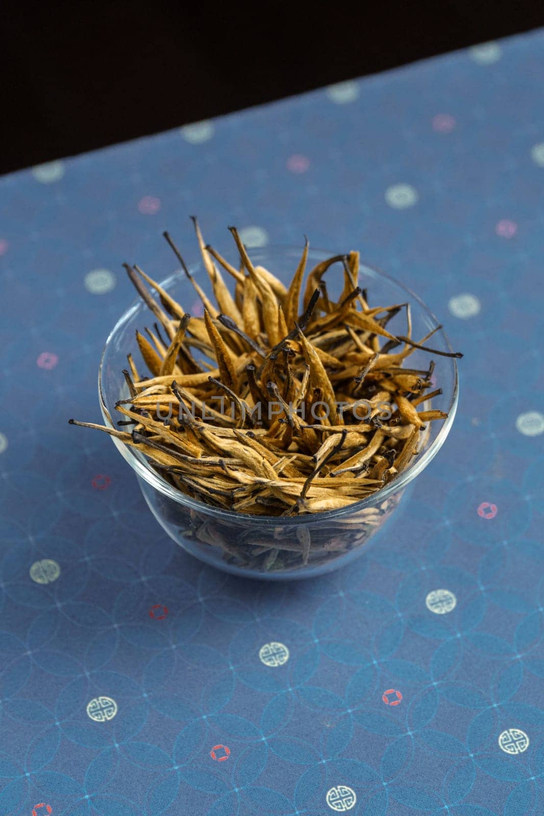 A bowl overflowing with a variety of dried herbs, showcasing their rich textures and vibrant colors