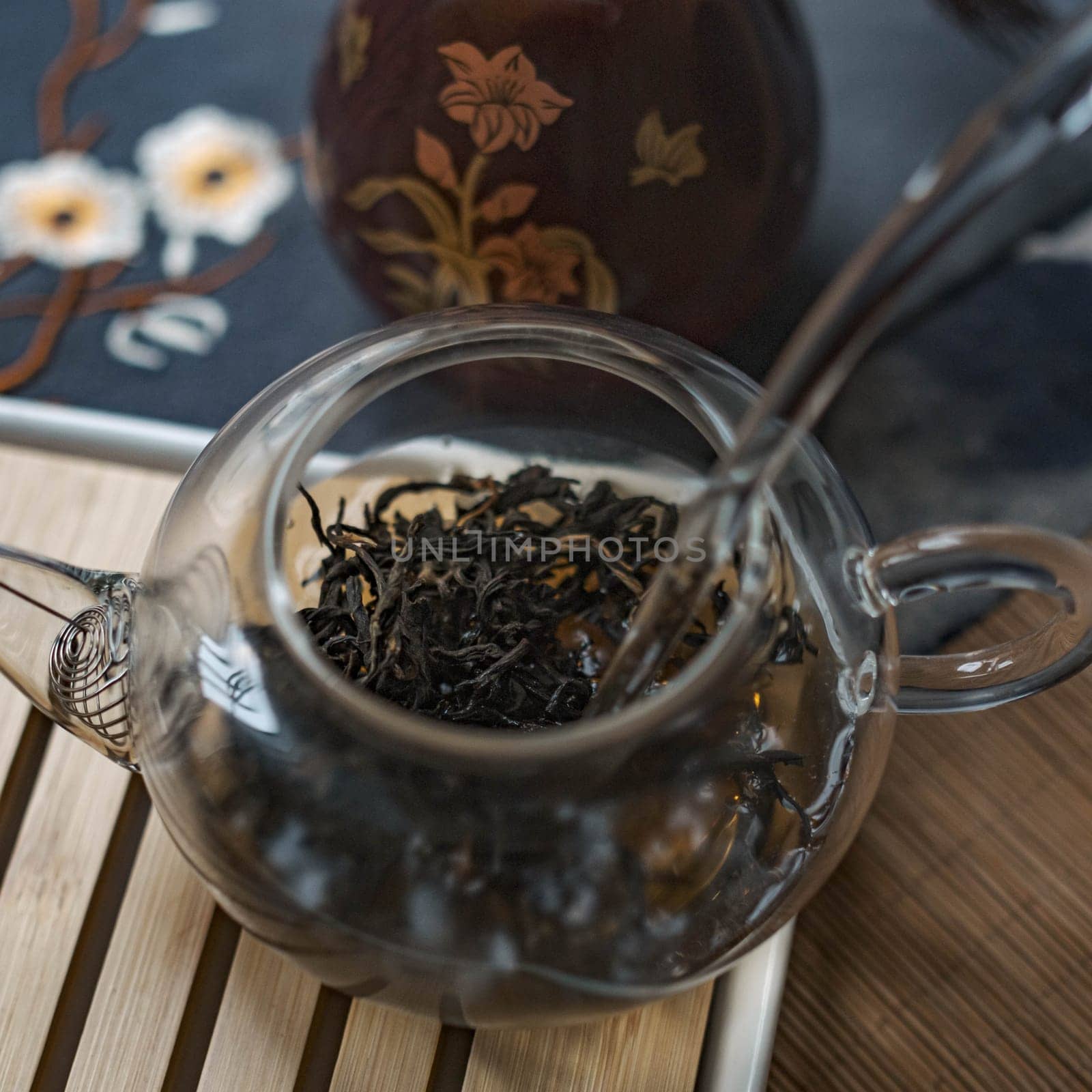 An aesthetic image showcasing tea leaves steeping beautifully in a glass teapot, perfect for dedicated tea enthusiasts